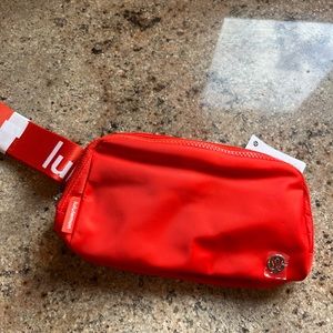 Lululemon- NWT
Everywhere Belt Bag 
Solar Orange/White